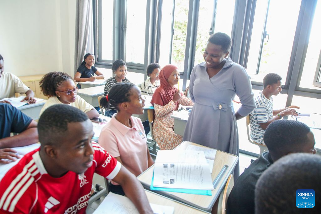 Tanzanian Chinese language teacher Gloria Mshana walks among the students to guide a class at the Confucius Institute at the University of Dar es Salaam in Dar es Salaam, Tanzania, Oct. 1, 2026. As the world prepares to mark World Teachers' Day on Oct. 5, Chinese and Tanzanian educators are joining forces to expand Chinese language education in Tanzania, blending native linguistic expertise with localized cultural insights.(Xinhua/Emmanuel Herman)