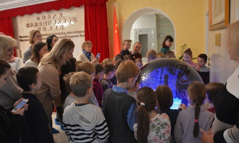 Local elementary school students and their parents visit the exhibition hall