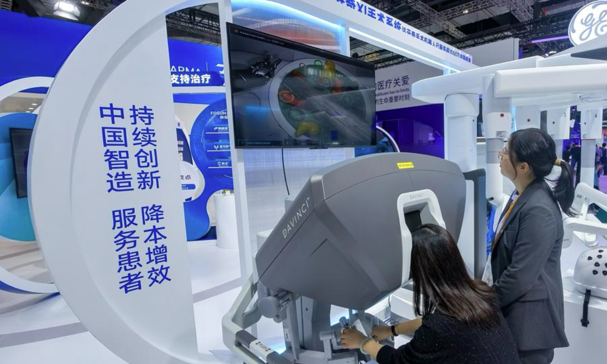 A visitor tries a surgery robot at the booth of Fosunpharma at the Medical Equipment & Healthcare Products Exhibition Area during the 7th China International Import Expo (CIIE) in east China's Shanghai, Nov. 8, 2024. (Xinhua/Zhang Cheng)
