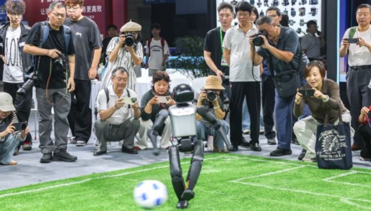 Diverse robot applications showcased at 2026 WMC 	 	Visitors watch a robot playing football at the 2026 World Manufacturing Convention (WMC) in Hefei, east China's Anhui Province, Sept. 21, 2026. The ongoing 2026 WMC showcases wide-ranging applications of robots.